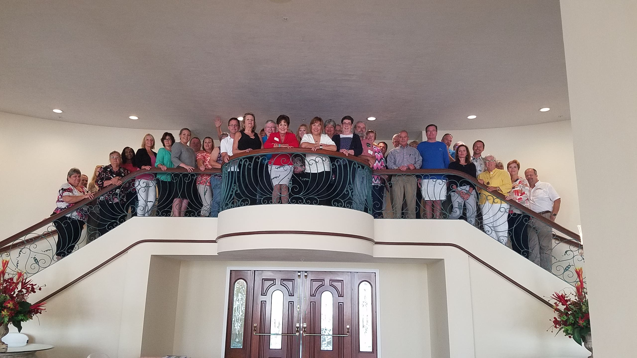 A group of people standing on top of a balcony.