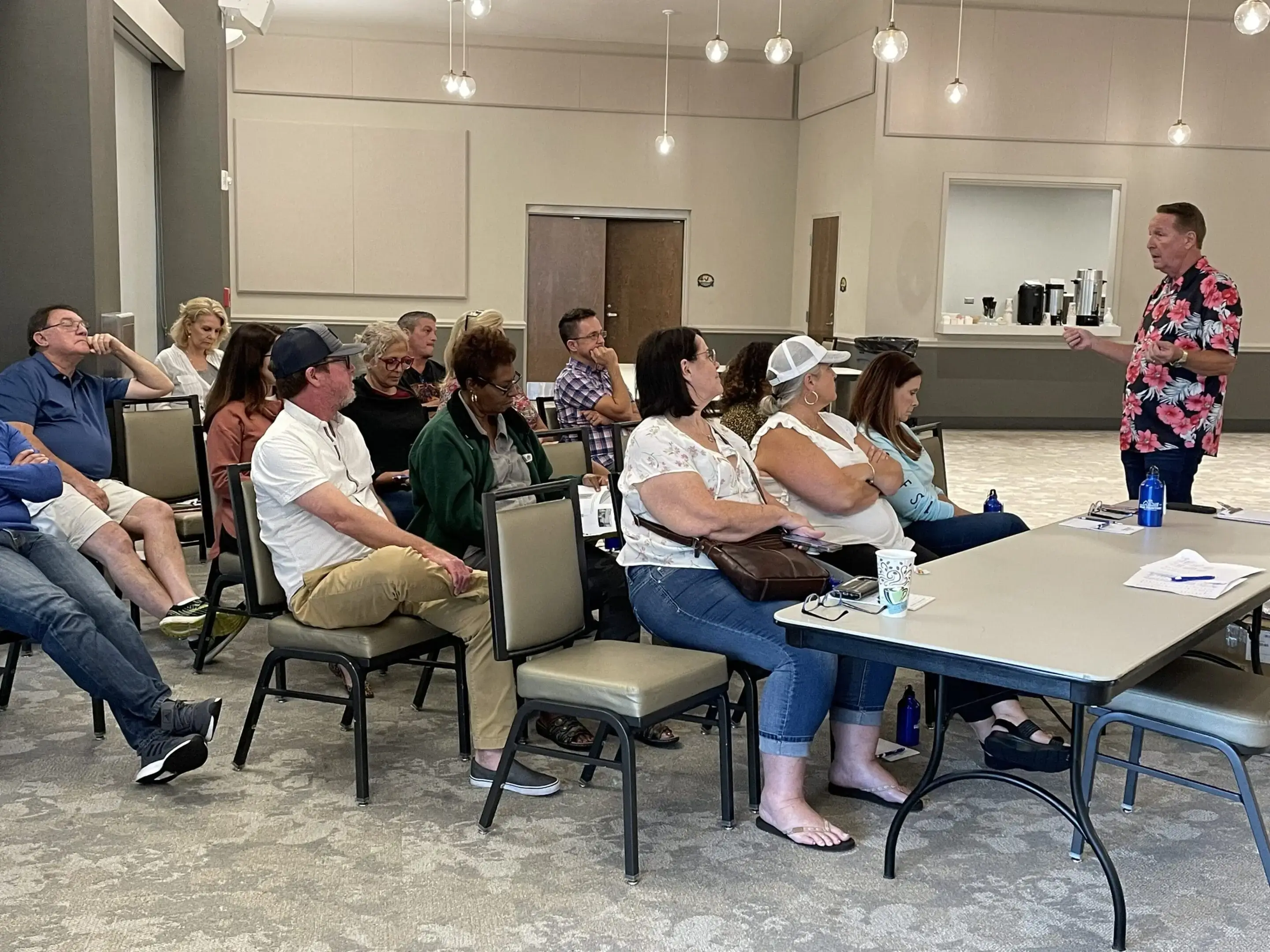 Community meeting with presenter in conference room